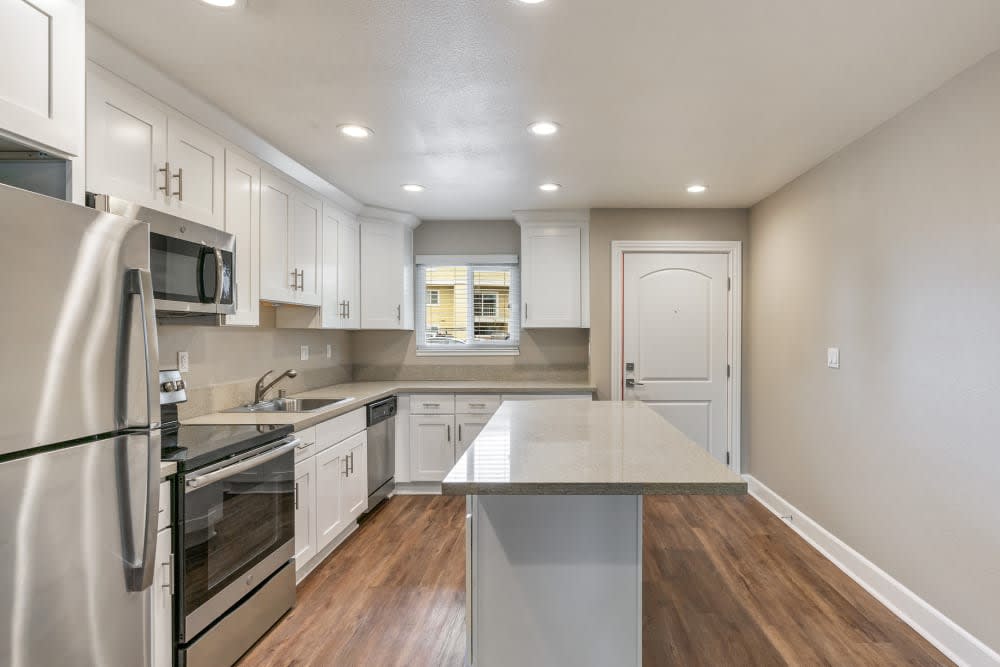 Upscale kitchen with island seating at Pentagon Apartments in Fremont, California