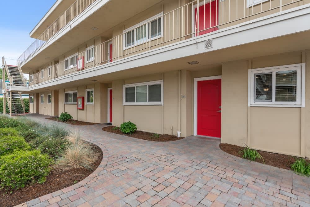 Building exterior and walkway at Pentagon Apartments in Fremont, California
