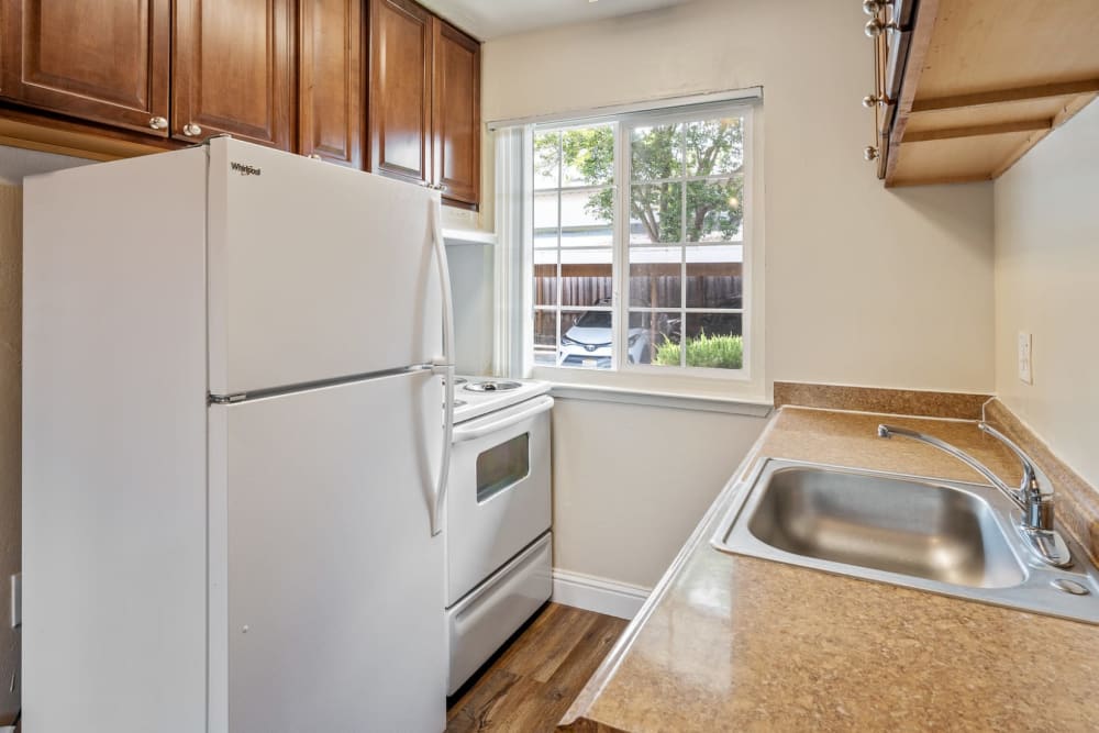 Kitchen with white appliances at Mountain View Apartments in Concord, California