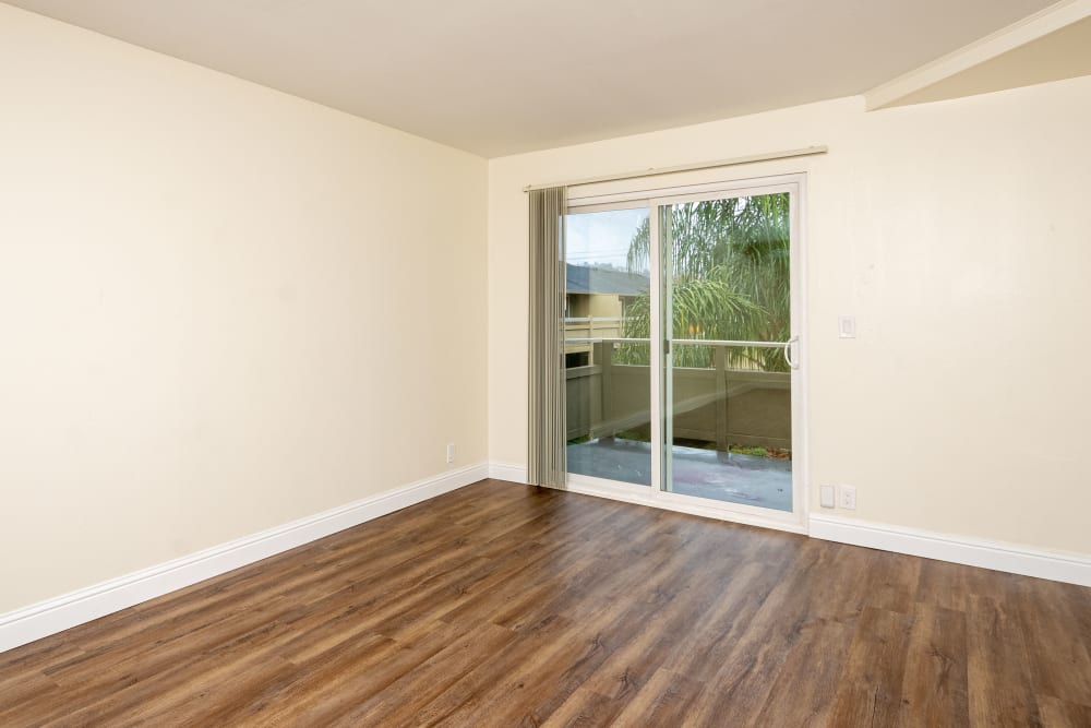 Living room with floor to ceiling windows at Bayfair Apartments in San Lorenzo, California