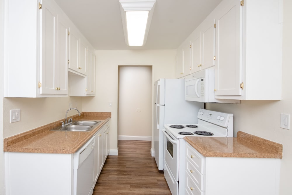Full kitchen with counters on each side at Bayfair Apartments in San Lorenzo, California
