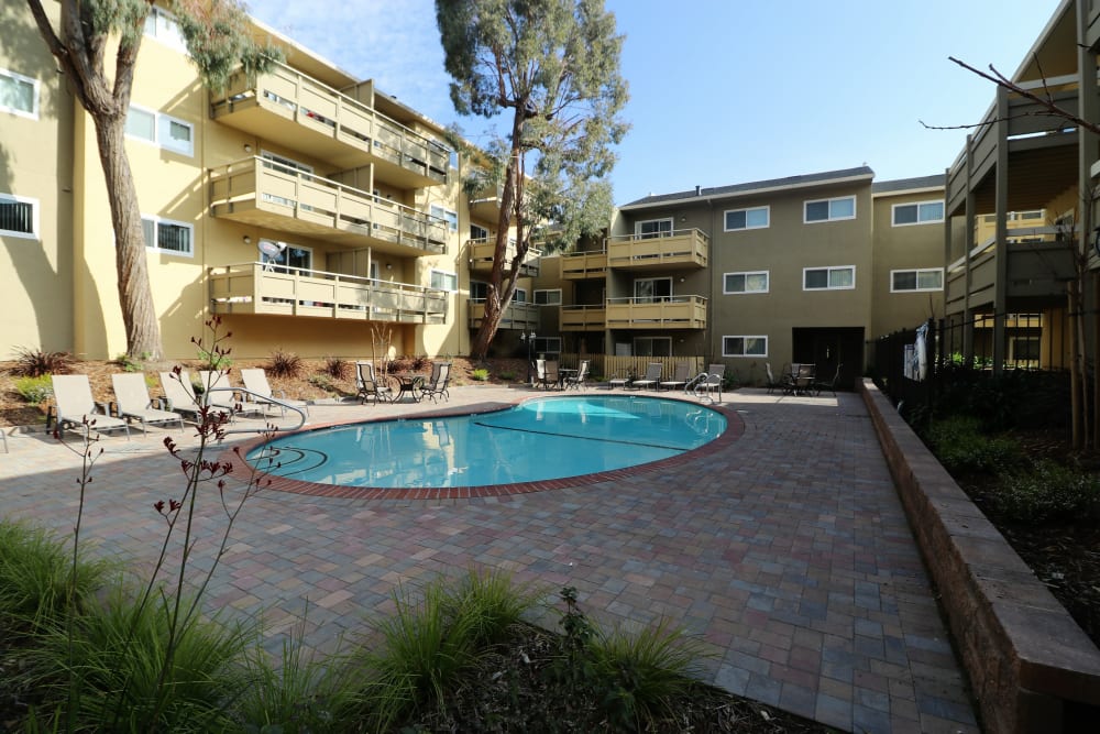 Pool in interior courtyard with apartments surrounding it at Bayfair Apartments in San Lorenzo, California