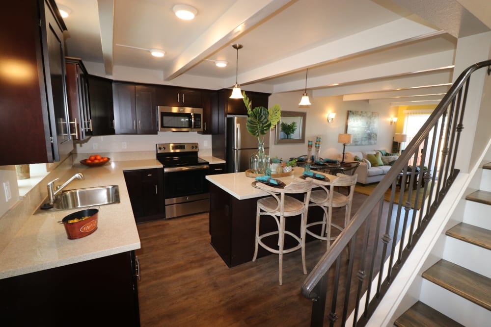 Kitchen with island seating and pendant lighting at Ramblewood Apartments in Fremont, California