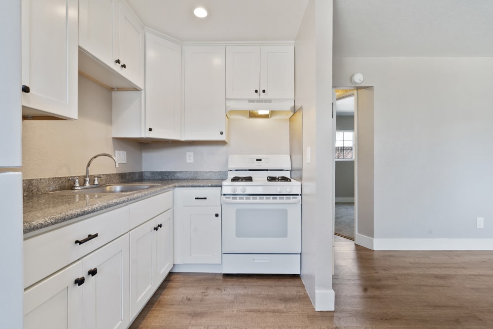 Open apartment kitchen with a gas range at Royal Gardens Apartments in Livermore, California
