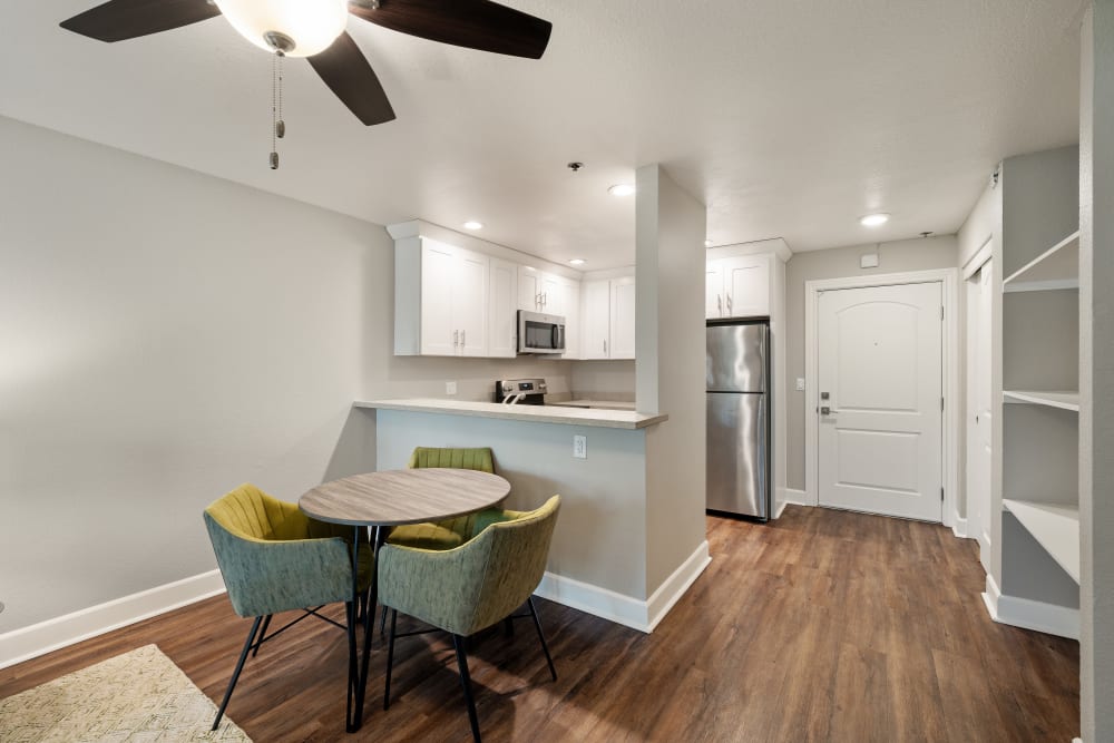 Dining area and kitchen of a model apartment home at Summerhill Terrace Apartments in San Leandro, California