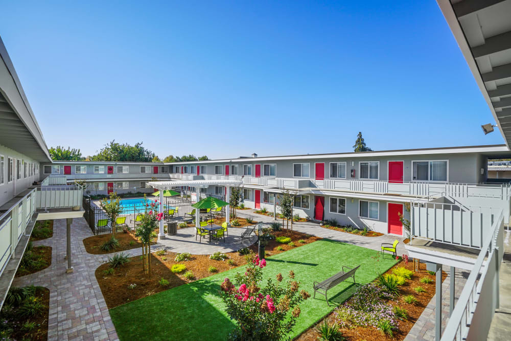 Outdoor courtyard with landscaping and patio seating at Bon Aire Apartments in Castro Valley, California