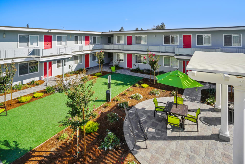 Outdoor courtyard patio with dog run and seating at Bon Aire Apartments in Castro Valley, California