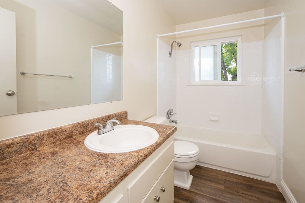 Bathroom with large counter space at Marina Plaza Apartments in San Leandro, California