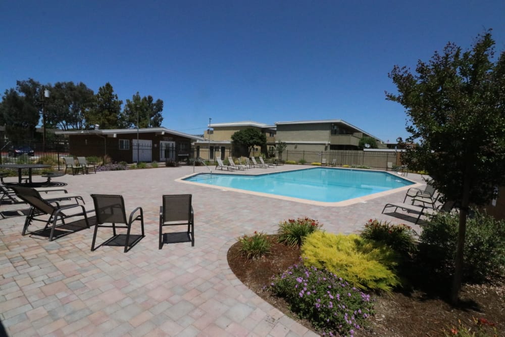 Resort-style swimming pool seating area at Briarwood Apartments in Livermore, California