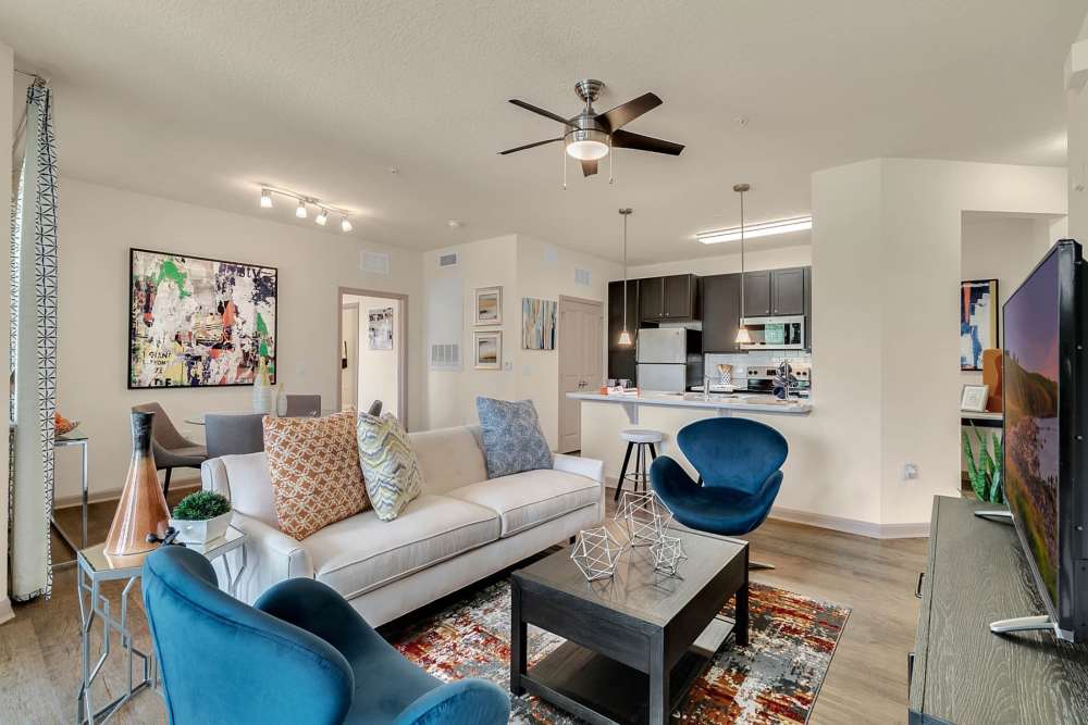Spacious apartment living room with kitchen access at Art Avenue Apartment Homes in Orlando, Florida
