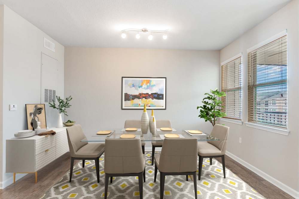 Apartment formal dining room with large windows at Art Avenue Apartment Homes in Orlando, Florida