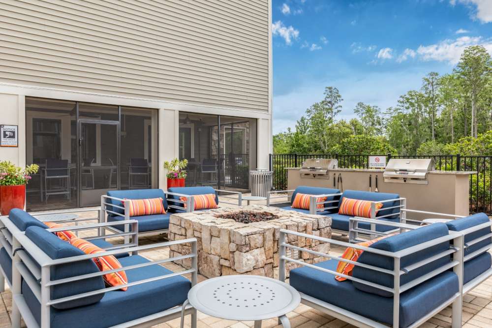 Outdoor firepit with comfy seating at Art Avenue Apartment Homes in Orlando, Florida