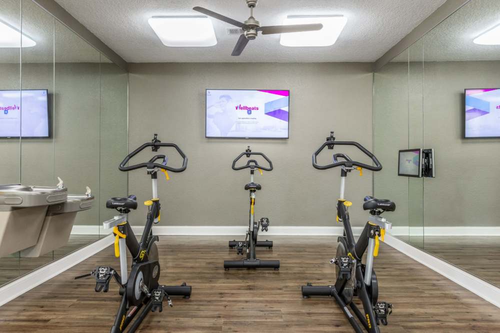 Community fitness center with stationary bicycles at Art Avenue Apartment Homes in Orlando, Florida