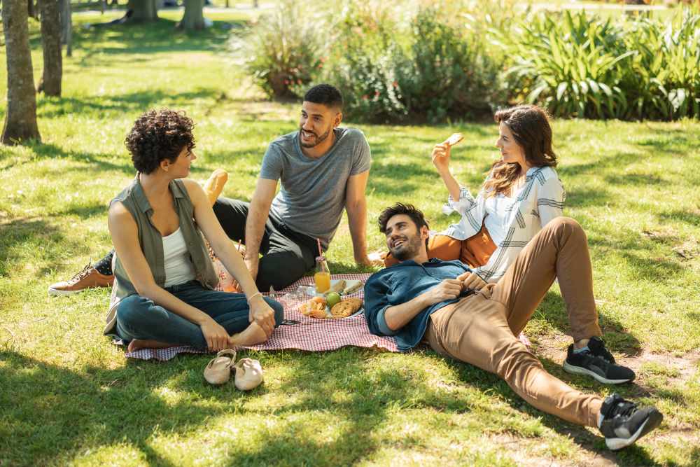 Group of 4 friends enjoying a picnic near Art Avenue Apartment Homes in Orlando, Florida