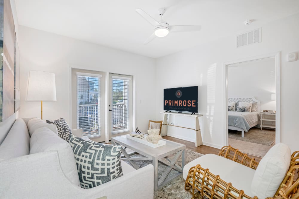 Spacious living room with balcony access at Primrose at Santa Rosa Beach in Santa Rosa Beach, Florida