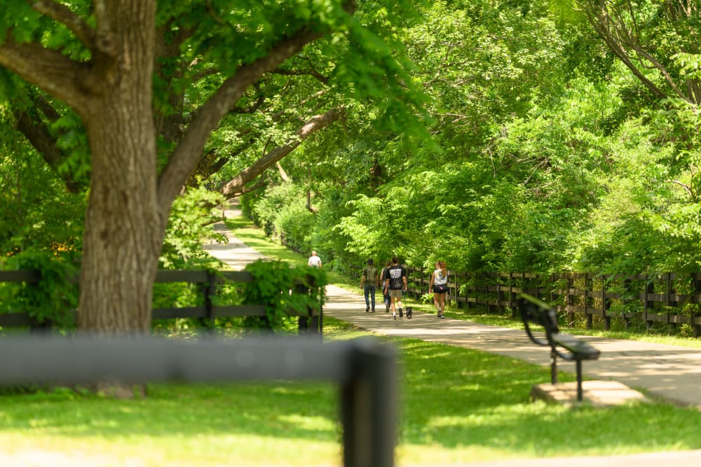 Residents walking with their dog near Beaumont Farms Apartments in Lexington, Kentucky