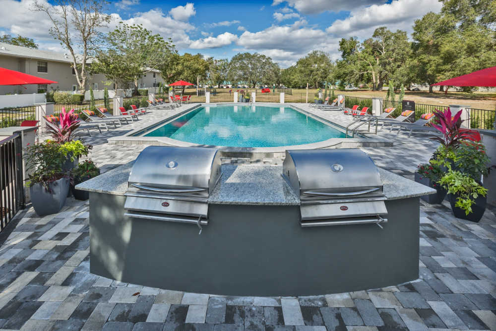 Outdoor kitchen with grills by the pool at Barrington Place at Winter Haven in Winter Haven, Florida