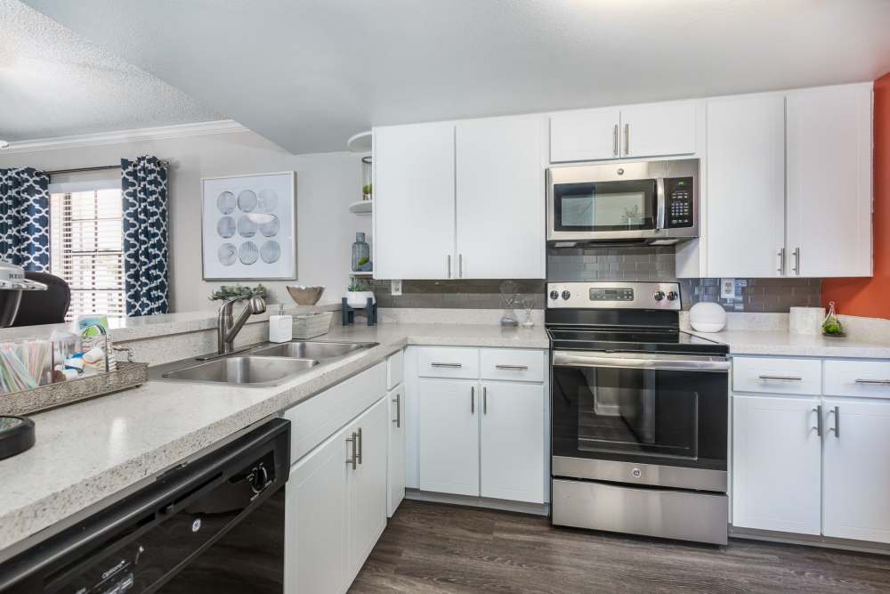 Apartment kitchen with white cabinets and countertops at Barrington Place at Winter Haven in Winter Haven, Florida