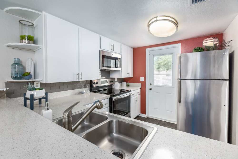 Modern apartment kitchen with stainless steel appliances at Barrington Place at Winter Haven in Winter Haven, Florida