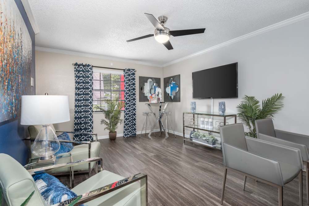Furnished living with hardwood floors and ceiling fan at Barrington Place at Winter Haven in Winter Haven, Florida