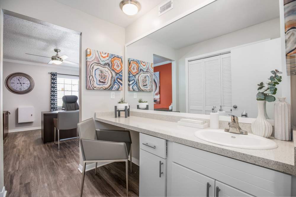 Spacious bathroom with large vanity and mirror at Barrington Place at Winter Haven in Winter Haven, Florida