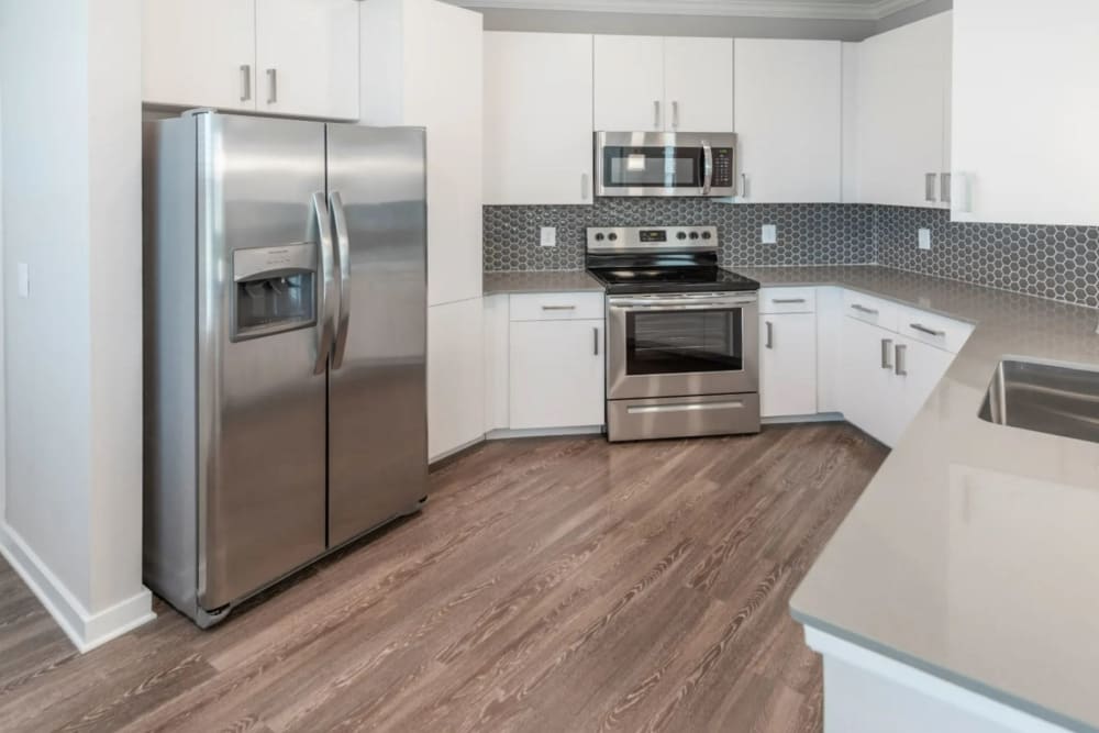 Kitchen with wood-style flooring at Verso Luxury Apartments in Davenport, Florida