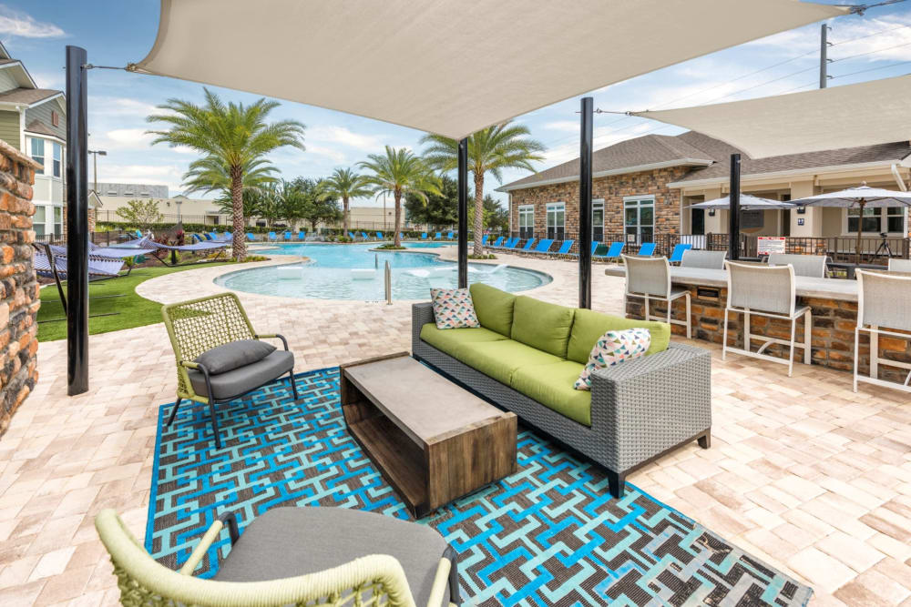 Outdoor lounge by the pool at Verso Luxury Apartments in Davenport, Florida