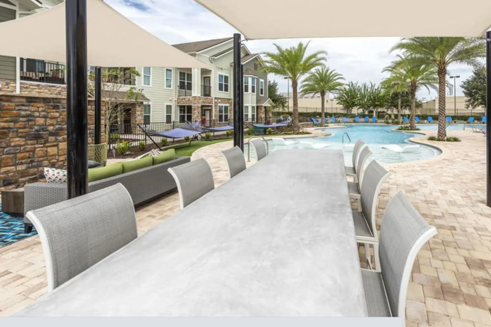 Large dining table outside at Verso Luxury Apartments in Davenport, Florida