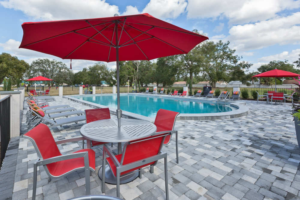 Seating by the pool at Barrington Place at Winter Haven in Winter Haven, Florida