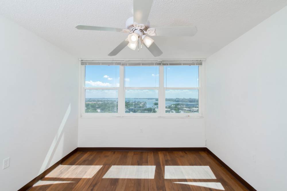Apartment room with scenic view and ceiling fan at Bay Pointe Tower in South Pasadena, Florida