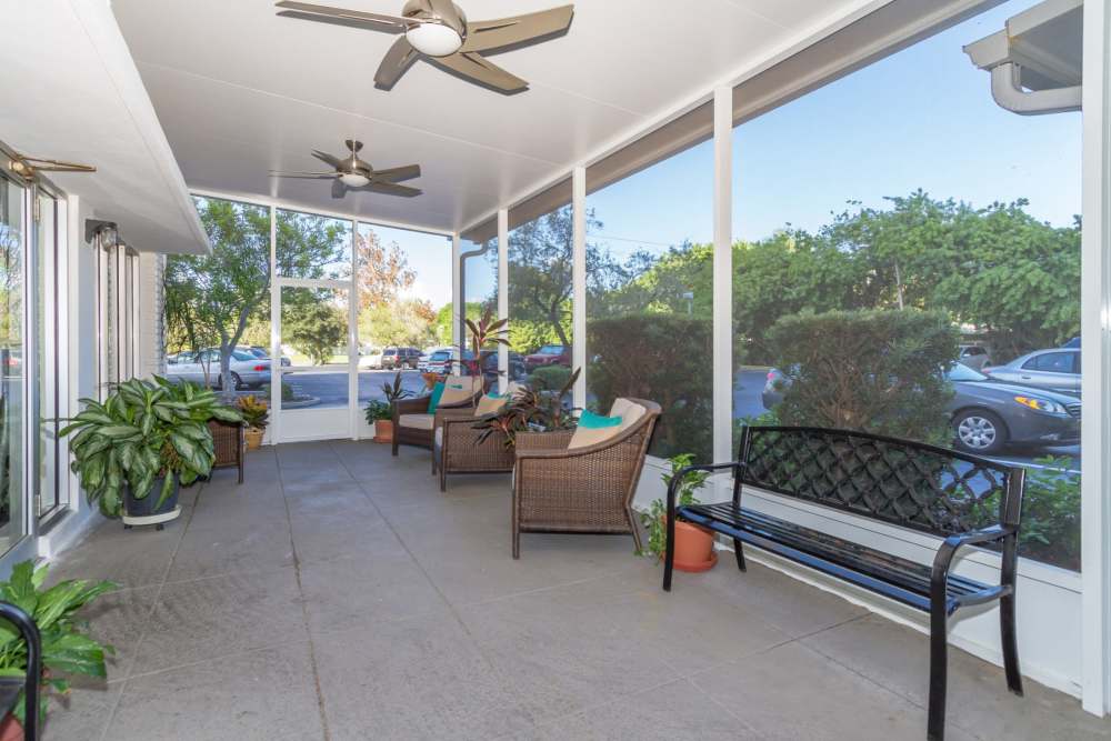 Screened in porch with seating at Bay Pointe Tower in South Pasadena, Florida
