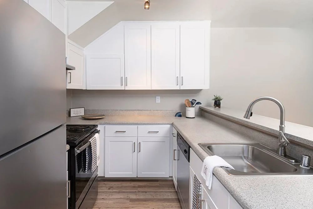 Kitchen with stainless-steel appliances at Americana Apartments in Rohnert Park, California