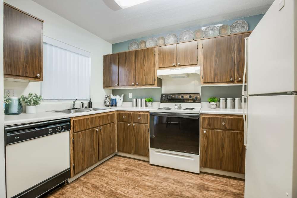 Apartment kitchen with wooden cabinets and major appliances at Briarcrest at Winter Haven in Winter Haven, Florida