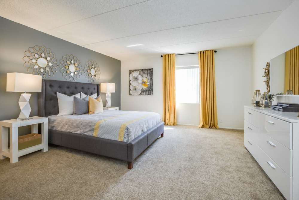 Carpeted apartment bedroom with sunlit window at Briarcrest at Winter Haven in Winter Haven, Florida