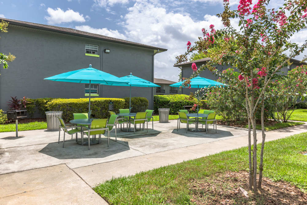 Outdoor patio with covered umbrella seating at Central Place at Winter Park in Winter Park, Florida
