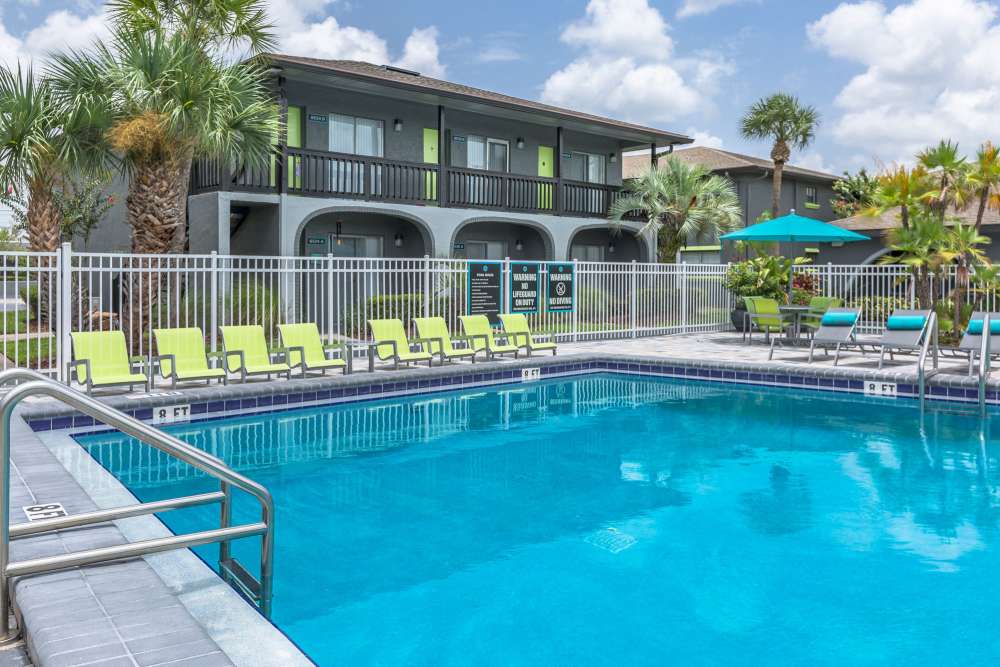 Luxury inground pool with lounge chairs at Central Place at Winter Park in Winter Park, Florida