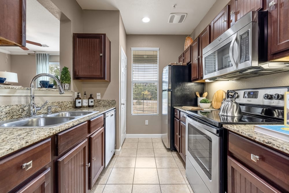 Stainless steel stove and microwave and beautiful kitchen at Marquis at Crown Ridge in San Antonio, Texas