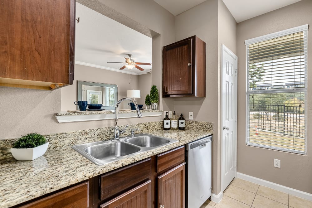 Stainless steel stove and microwave and beautiful kitchen at Marquis at Crown Ridge in San Antonio, Texas