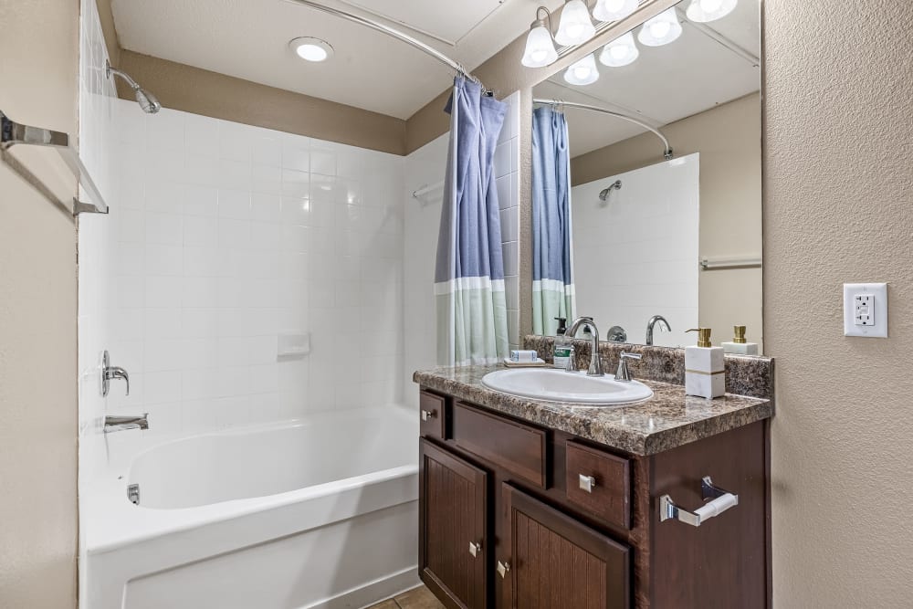 Bathroom with dark colored cabinets at Marquis at Crown Ridge in San Antonio, Texas