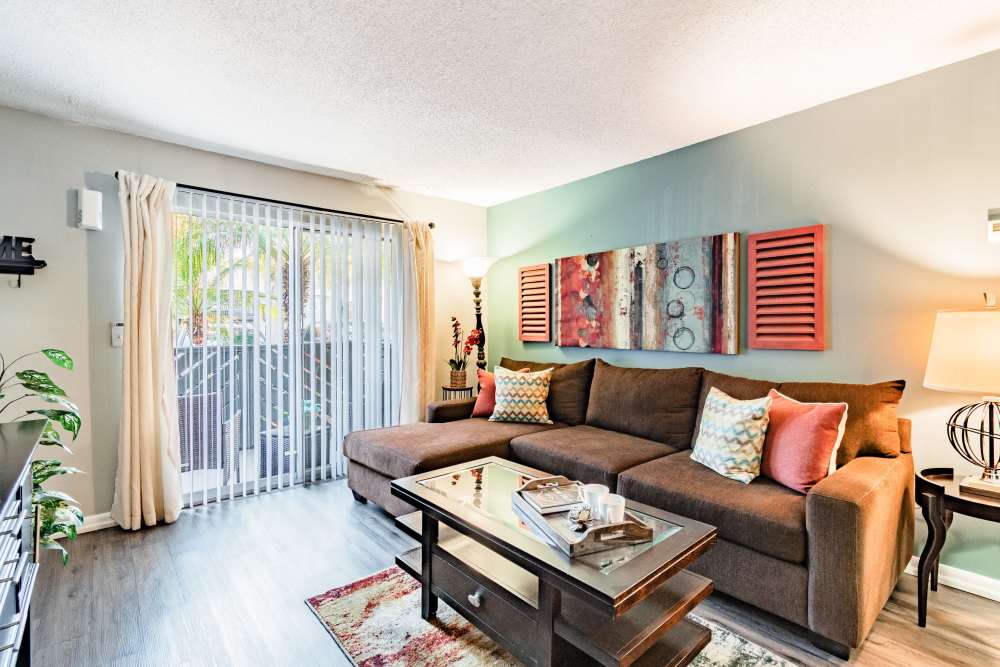 Apartment living room with brown sofa and coffee table at Coopers Pond in Tampa, Florida