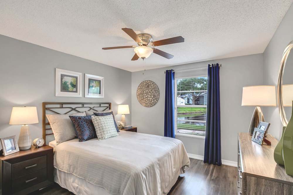 Apartment bedroom with hardwood floors and ceiling fan at Lakeside Central Apartments in Brandon, Florida