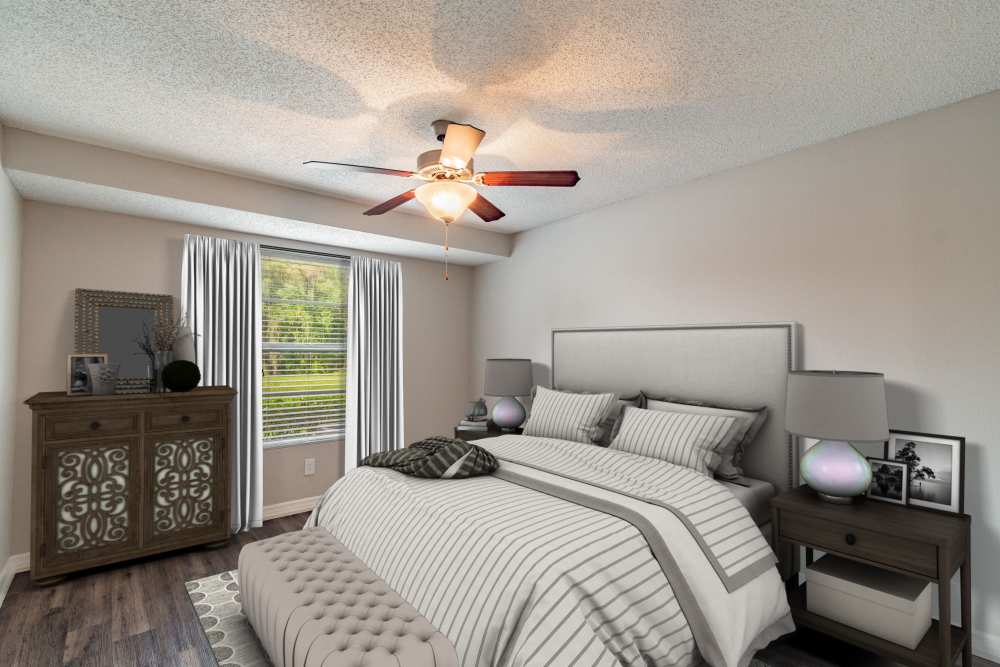 Apartment bedroom with large window and ceiling fan at Lakeside Central Apartments in Brandon, Florida
