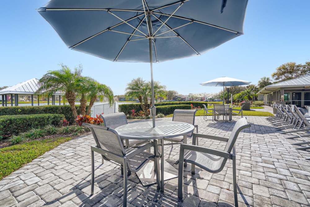 Stone patio with seating at Lakeside Central Apartments in Brandon, Florida