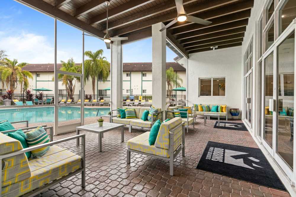 Screened-in poolside lounge at Nova Central Apartments in Davie, Florida