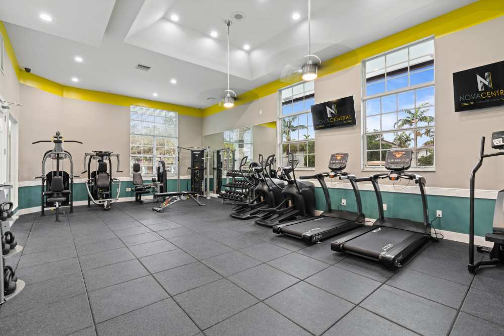Community gym with cardio and weight machines at Nova Central Apartments in Davie, Florida