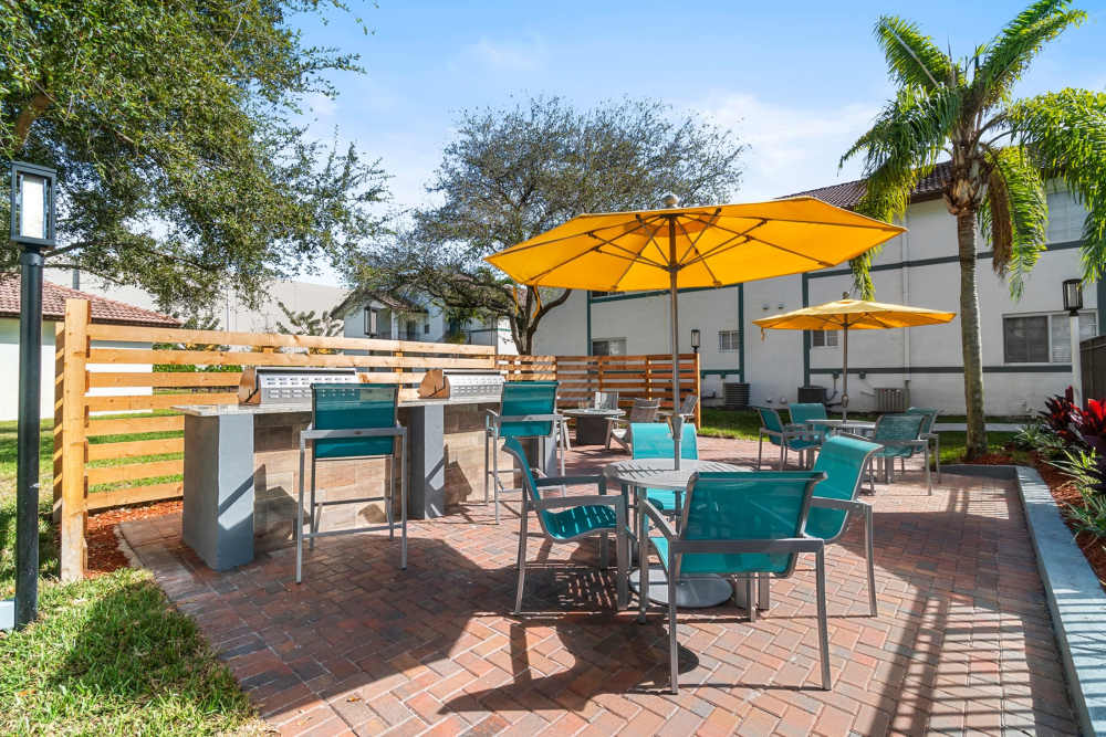 Community patio area with grilling station at Nova Central Apartments in Davie, Florida