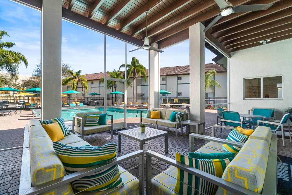 Outdoor lounge area by the pool at Nova Central Apartments in Davie, Florida