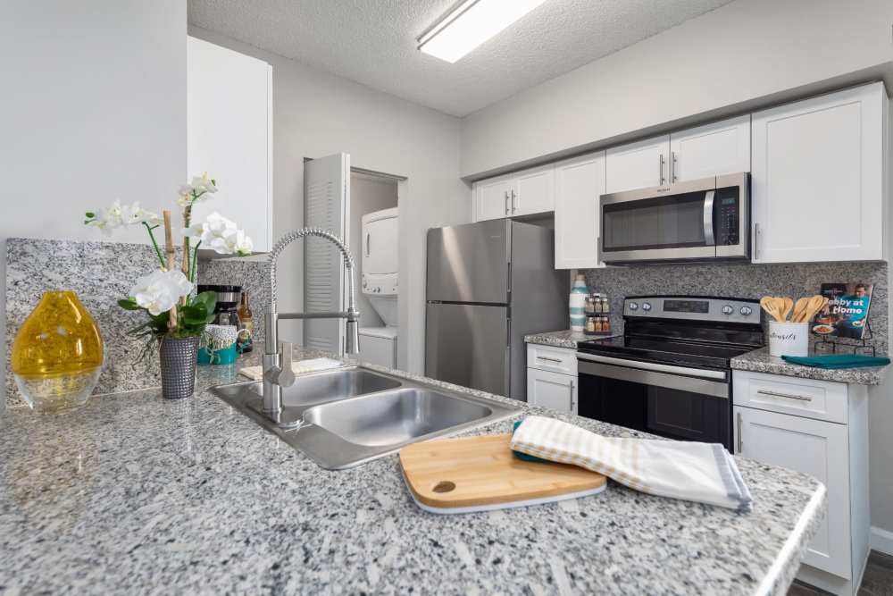 Modern kitchen with stainless steel appliances at Nova Central Apartments in Davie, Florida