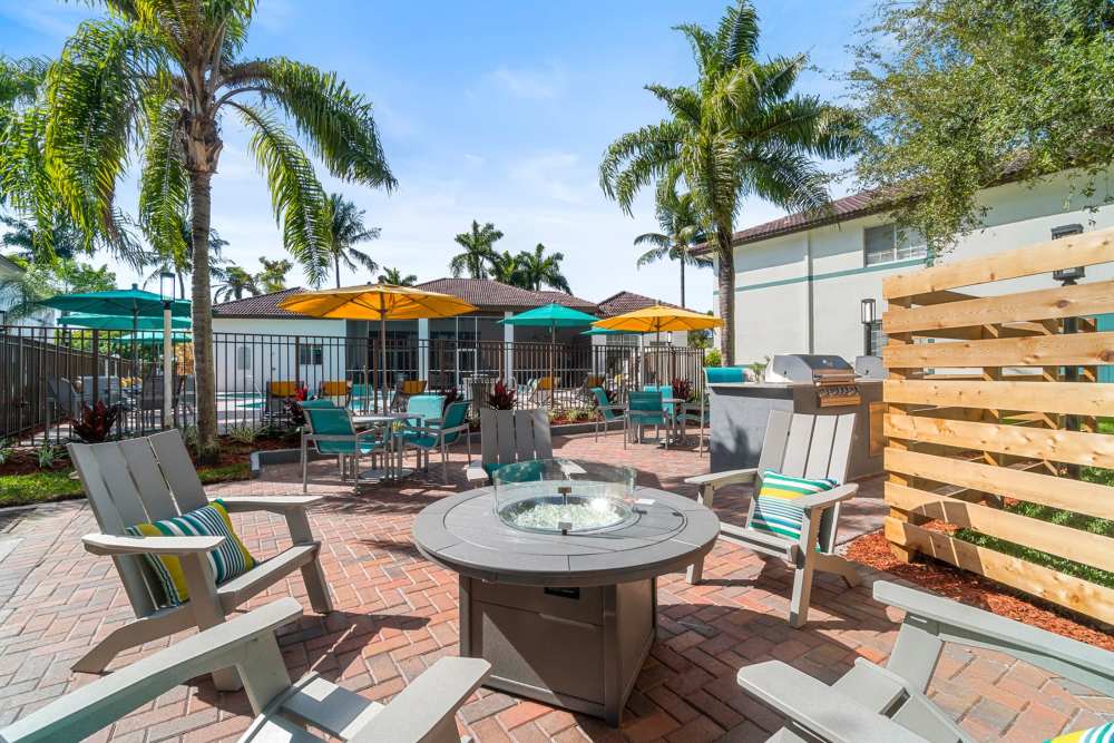 Community fire pit and seating at Nova Central Apartments in Davie, Florida