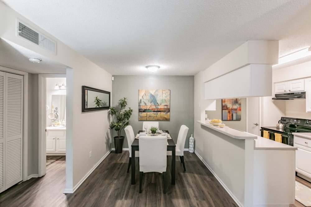 Dining area with hardwood floors in apartment at Legend Oaks in Tampa, Florida